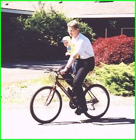 Daniel rides the bike with Dad